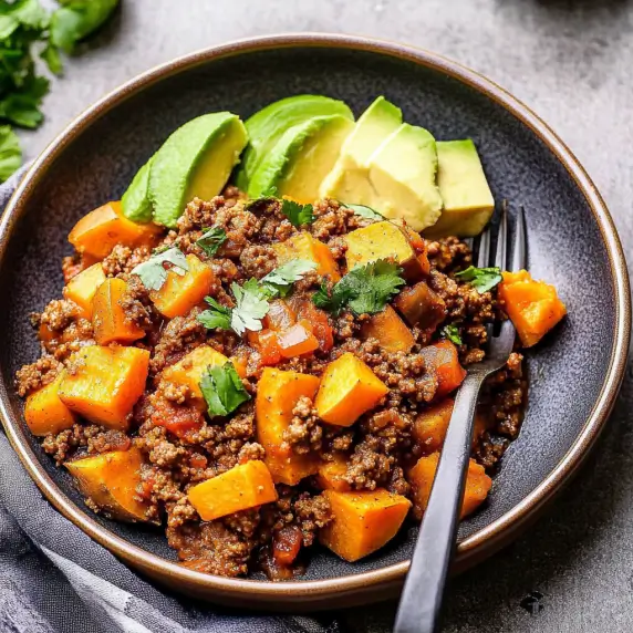 Savory ground beef and sweet potato skillet cooked with spices, bell peppers, and onions—perfect for a healthy, gluten-free meal.