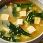 Warm miso soup made with fermented miso paste, soft tofu, wakame, and green onions in a traditional Japanese presentation