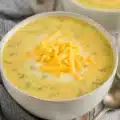 Instant Pot ham cheese broccoli soup served in a bowl with fresh ingredients.