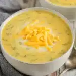 Instant Pot ham cheese broccoli soup served in a bowl with fresh ingredients.