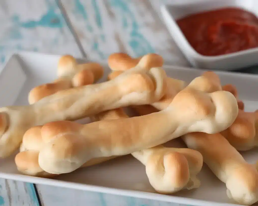 Spooky Cheesy Halloween Breadstick Bones served with marinara dip