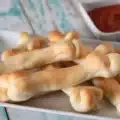 Spooky Cheesy Halloween Breadstick Bones served with marinara dip