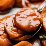 Delicious candied sweet potatoes, caramelized in a buttery glaze, perfect for Thanksgiving.