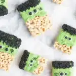 Spooky Frankenstein Halloween Rice Krispie Treats with candy eyes and green frosting.