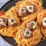 Spooky Spaghetti and Cheese Stuffed Meatballs served in a ghostly tomato sauce.