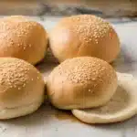 Homemade sourdough hamburger buns, soft and fluffy, perfect for summer BBQs.