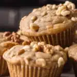 Plate of freshly baked sourdough banana muffins with ripe bananas and nuts.