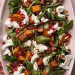 Roasted Sweet Potato Goat Cheese Salad with walnuts, cranberries, and arugula.