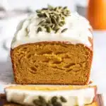 Moist and fragrant Spiced Pumpkin Loaf Cake displayed on a rustic wooden table.