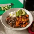 A delicious Sweet Potato Ground Beef Bowl topped with cottage cheese and avocado.