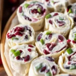 Cranberry Roll Ups filled with cream cheese, feta, and turkey, perfect for appetizers.