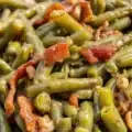 Delicious Crack Green Beans topped with crispy bacon and brown sugar glaze.