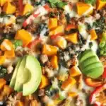 Ground turkey sweet potato bowl with colorful vegetables in a skillet