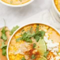 Mexican Street Corn Soup in a crockpot with corn, spices, and creamy ingredients.
