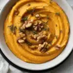 Creamy Pumpkin Whipped Feta Dip served with honey and walnuts, a perfect fall appetizer.