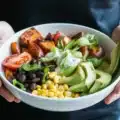 Assorted sweet potato bowls with various toppings including avocado, beans, and quinoa.