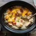 Delicious creamy Crack Chicken made with ranch, cheese, and bacon in a slow cooker.