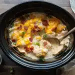 Delicious creamy Crack Chicken made with ranch, cheese, and bacon in a slow cooker.