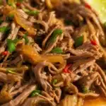 Mexican slow cooker chuck roast served with fresh cilantro and lime