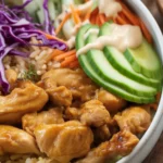 Delicious Bang Bang Chicken Bowl with seasoned chicken, veggies, and rice.