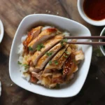 Delicious Sticky Chicken Rice Bowls topped with a sweet and savory sauce.