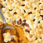 Delicious Sweet Potato Casserole with Marshmallows topped with gooey marshmallows and brown sugar.