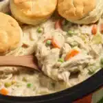 Delicious Crockpot Chicken Pot Pie served with biscuits in a bowl