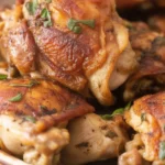 Juicy baked chicken thighs with crispy skin, seasoned for a flavorful dinner.