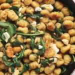 Delicious Gnocchi with Spinach and Feta dish served with herbs and creamy sauce