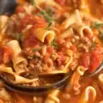 Delicious Crock pot lasagna soup with ground beef and creamy ricotta served in a bowl.