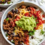 Delicious Taco Rice Bowl with ground beef, fresh veggies, and cilantro lime rice.