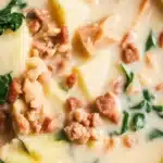Slow cooker Zuppa Toscana soup with sausage, potatoes, kale in a creamy broth.