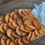 Delicious Sweet Potato & Cranberry Gratin topped with herbs and cheese, ideal for holiday meals.