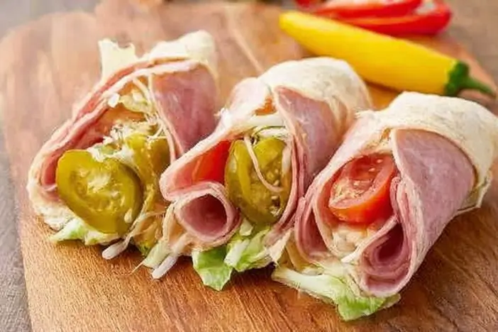 Keto Italian Sub Roll-Ups featuring layers of meat, cheese, and veggies.