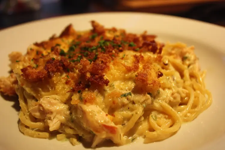 Delicious Spicy Southern Chicken Spaghetti Casserole topped with cheese and served in a dish.
