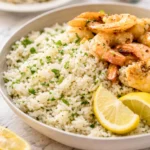 Delicious Greek Lemon Rice prepared with fresh herbs, garlic, and lemon juice.