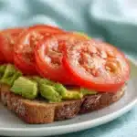 Delicious avocado-egg toast with a sunny side up egg on top