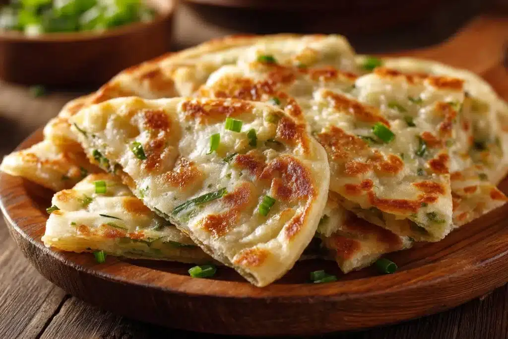 Crispy scallion pancakes (Cong You Bing) served on a plate with dipping sauce