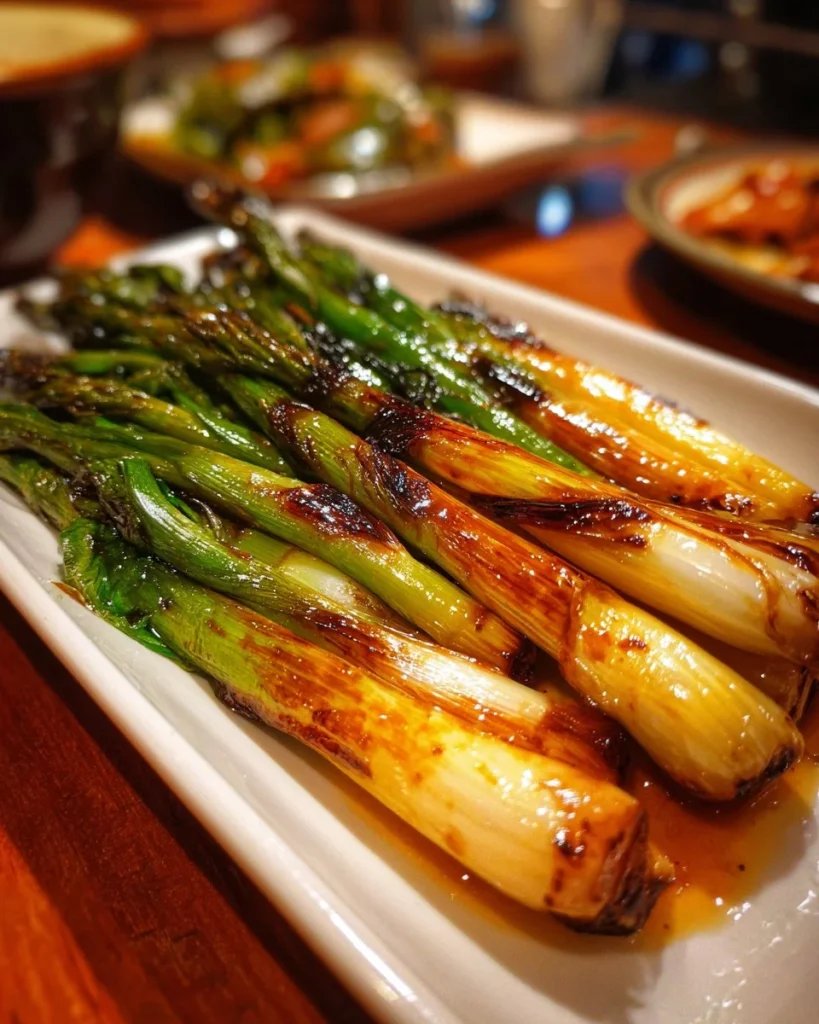 Healthy roasted spring onions on a plate, ready to serve for a tasty side dish.