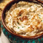 Creamy caramelized onion dip served with chips and veggies