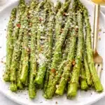 Air fryer roasted asparagus with olive oil and seasoning in a basket