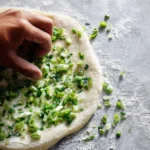 Crispy scallion pancakes served on a plate with dipping sauce