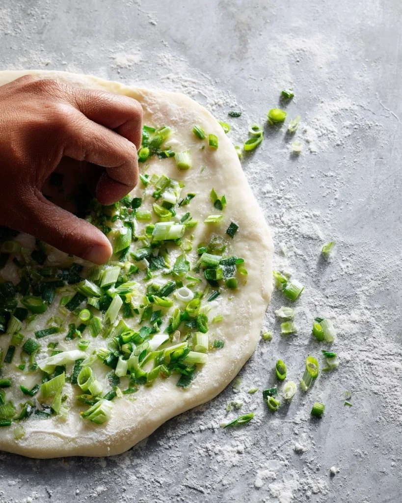 Crispy scallion pancakes served on a plate with dipping sauce