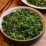 Two delicious versions of Korean Spinach Salad (Sigeumchi Namul) served in a bowl.