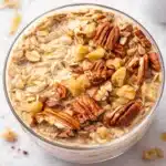 Creamy Maple Brown Sugar Overnight Oats in a jar with a sprinkle of cinnamon.