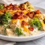 Creamy Low Carb Chicken Casserole topped with cheese and vegetables, perfect for keto diets.