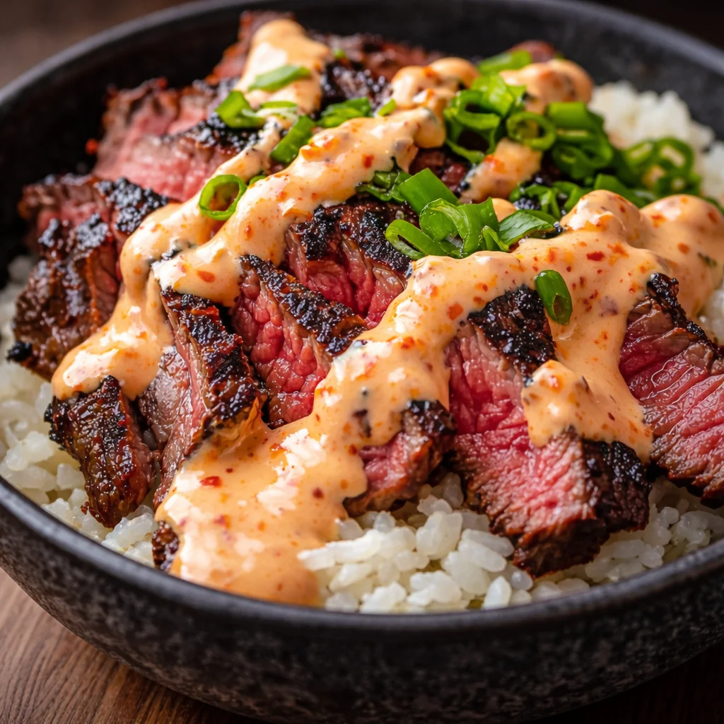 Korean BBQ Steak Rice Bowls with Spicy Cream Sauce, featuring tender beef and fresh vegetables.