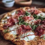 Delicious Prosciutto Burrata Pizza with honey drizzled on top