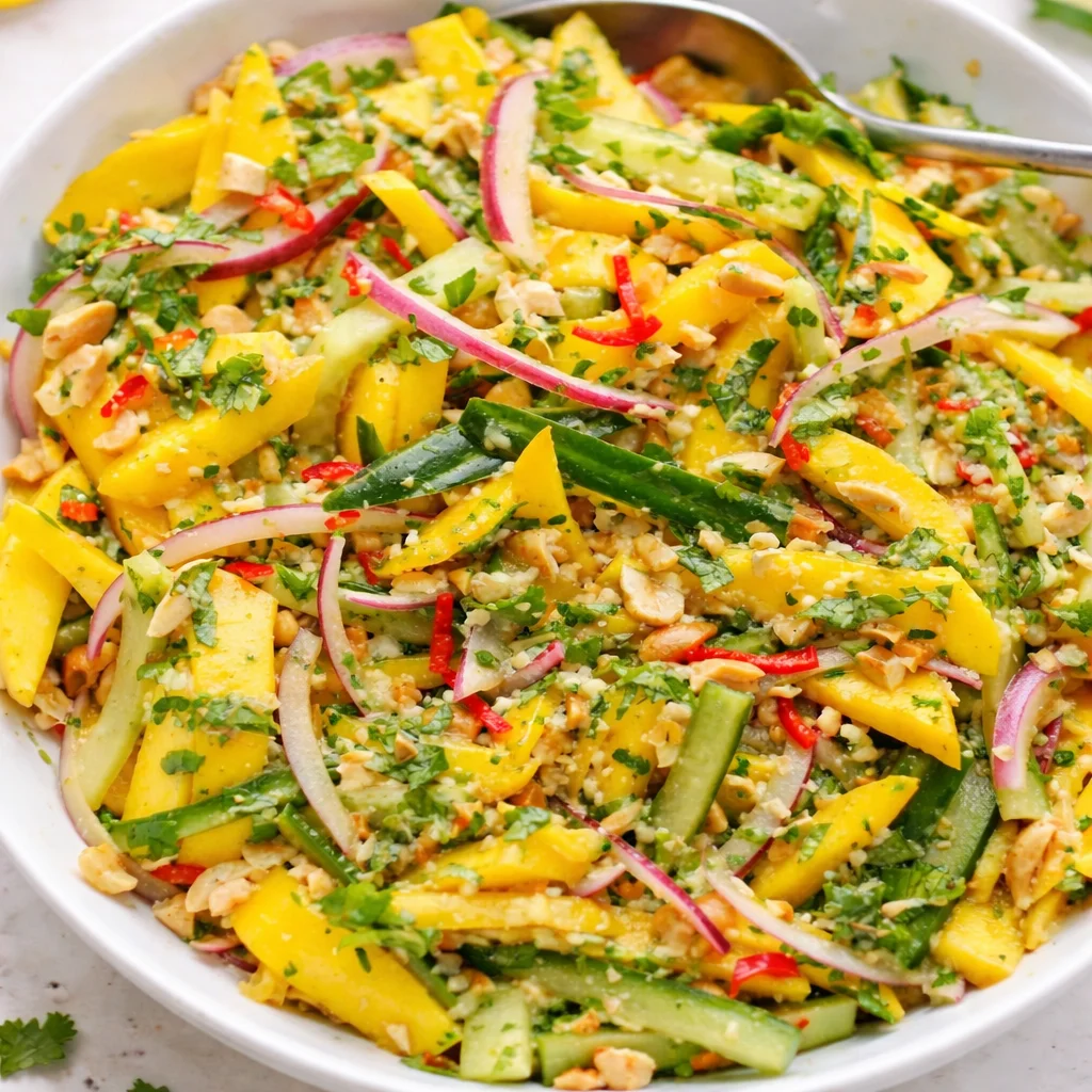 Zesty Thai Mango Salad with Crunchy Peanuts featuring vibrant ingredients and refreshing dressing.