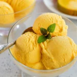 Delicious homemade mango ice cream featuring fresh mango chunks in creamy texture.